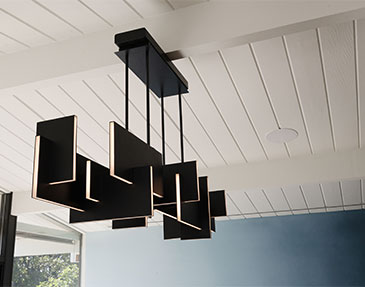 DRACO Design and Construction A black and white pendant light hanging from a ceiling.