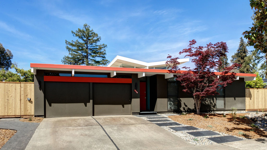 DRACO Design and Construction A modern home with a red door and garage.