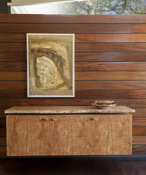 DRACO Design and Construction A wood paneled wall with a painting on it.