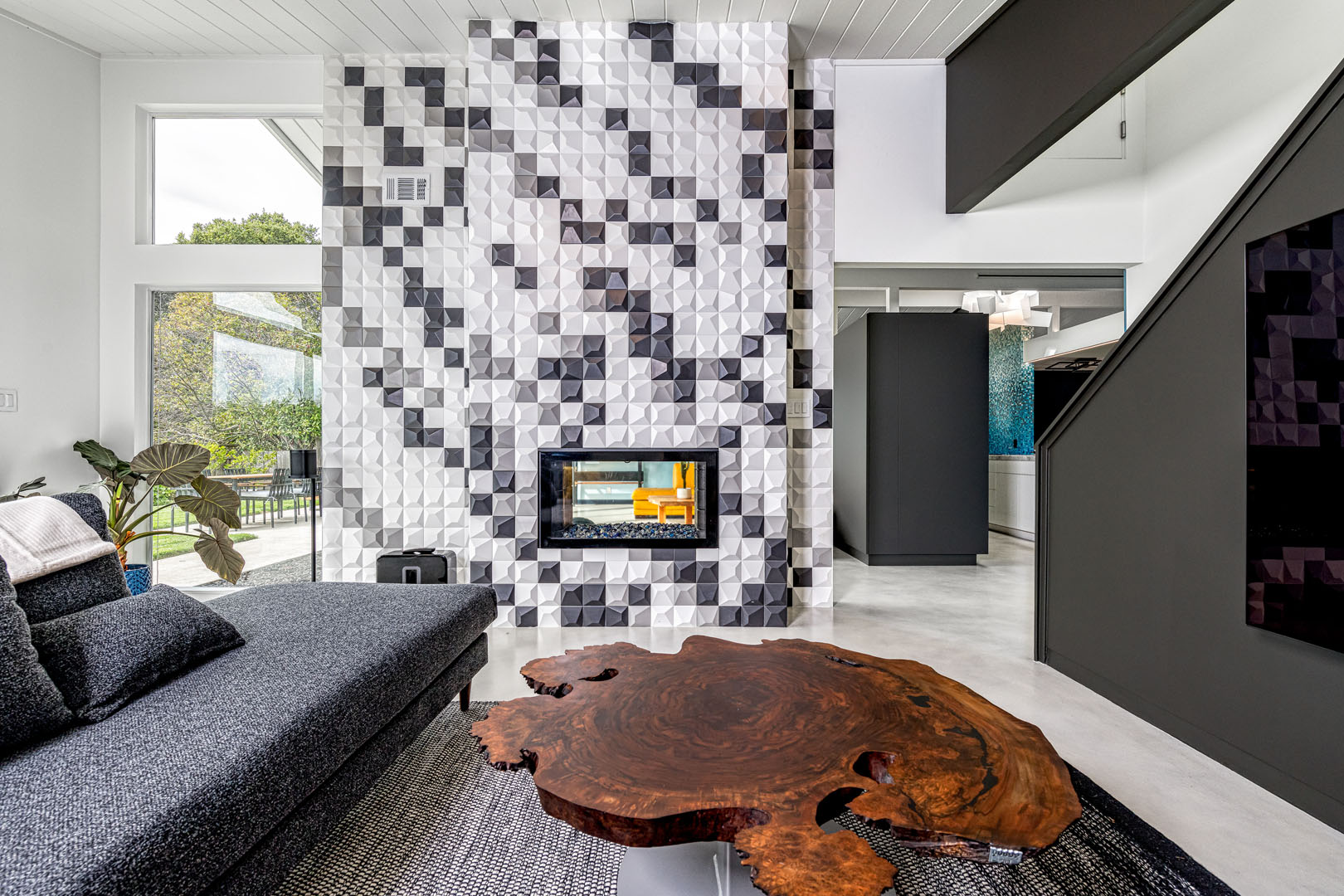 DRACO Design and Construction A living room with a fireplace and tiled walls.