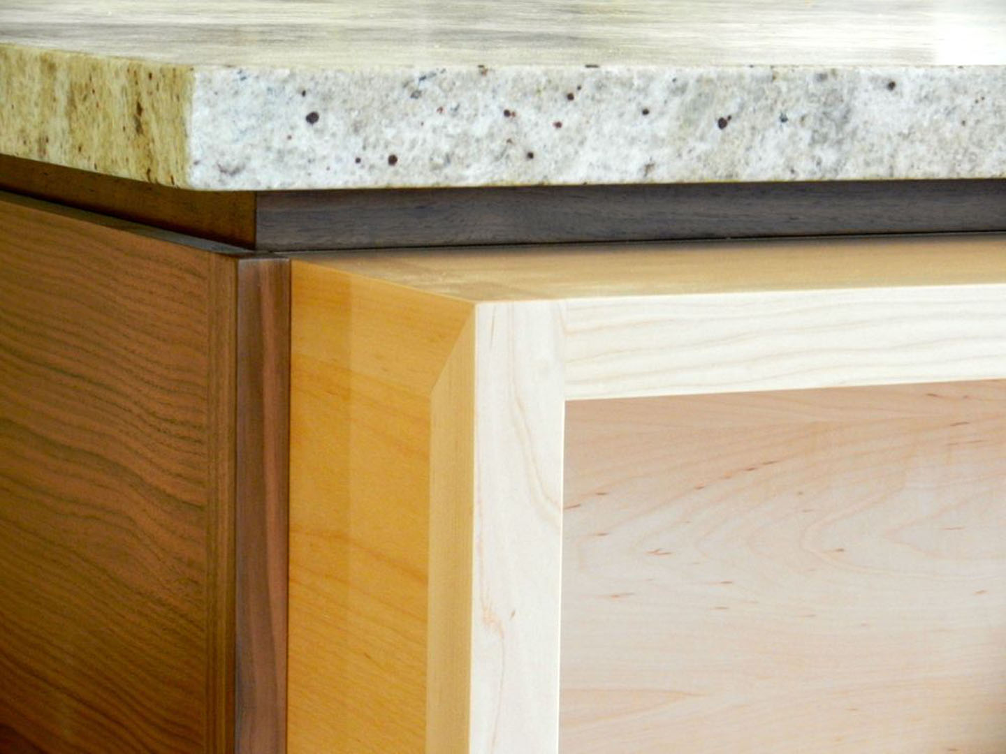 DRACO Design and Construction A close up of a kitchen island with a granite countertop.